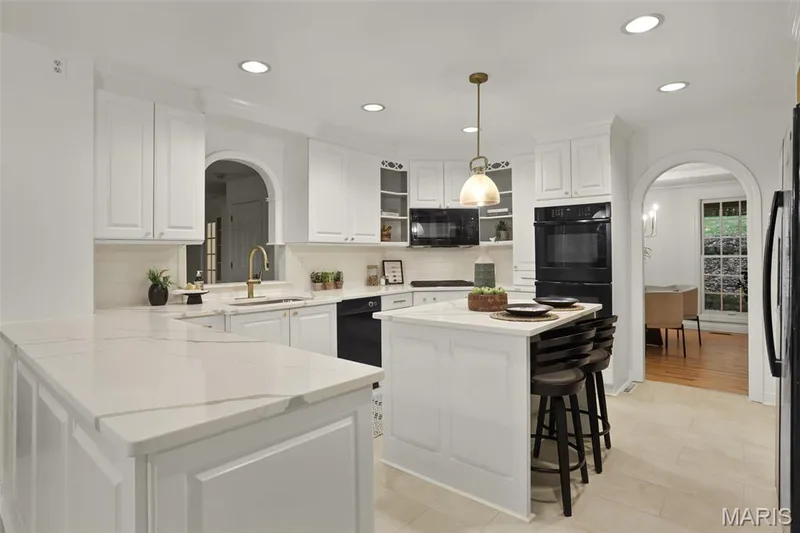 Kitchen featuring white cabinetry, stone-look countertops, a central island, recessed lighting, and dual wall-mounted ovens — 229 Quail Run Drive, Defiance, MO 63341