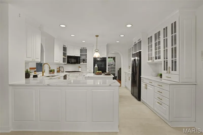 Kitchen featuring white cabinetry with glass-front uppers, stone-surface countertops, center island, recessed lighting, and tile flooring — 229 Quail Run Drive, Defiance, MO 63341