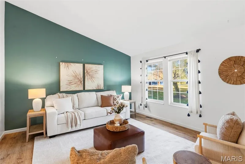 Vaulted ceiling, accent wall, and wood-finish flooring — 10341 Rose Lane, Foristell, MO 63348