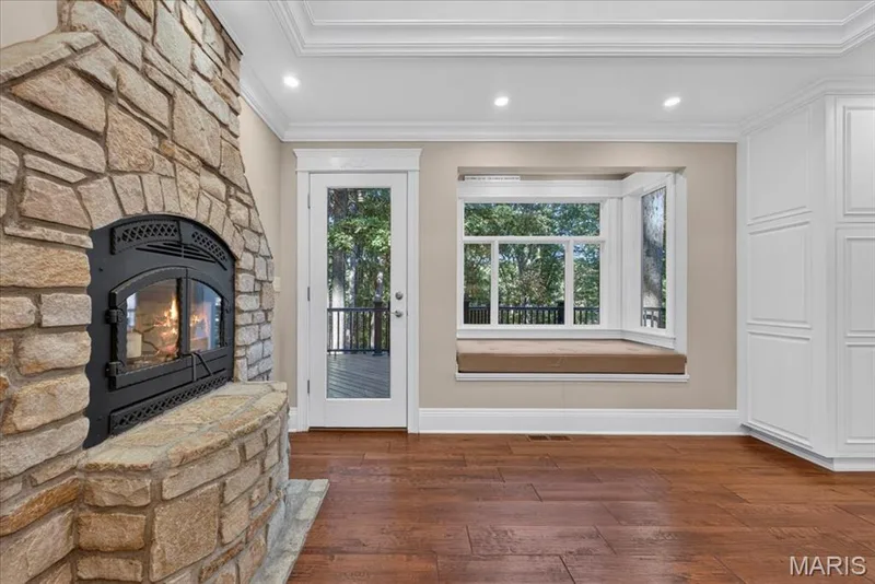 Fireplace in kitchen eating area. Window seat in kitchen. — 2436 Indian Tree Run, Wildwood, MO 63038