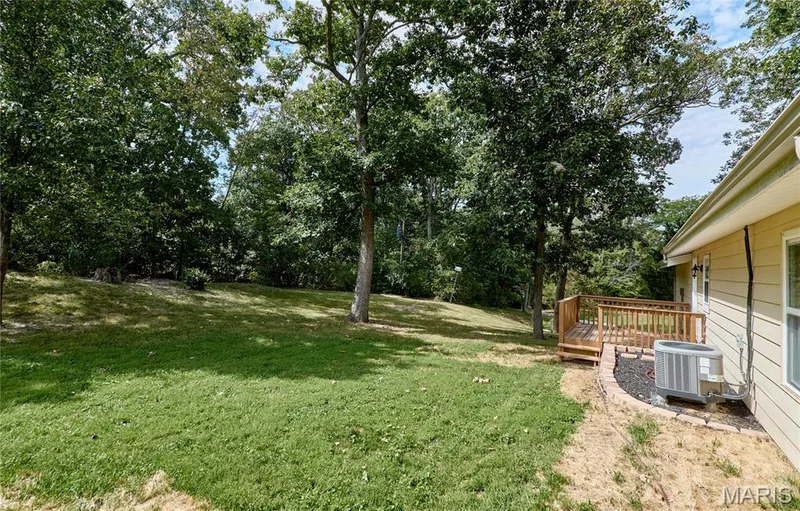 Expansive backyard with plenty of room for bar-b-ques and outdoor activities. Surrounded by mature trees. — 408 Raymond Drive, O'Fallon, MO 63366