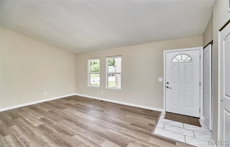 Walking in to an open floor plan continues from living room into the Dining room / Kitchen area and the hallway. — 408 Raymond Drive, O'Fallon, MO 63366