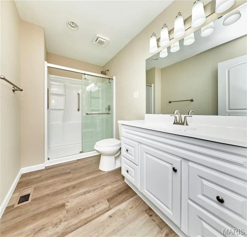 New Bathroom with White shaker-style cabinets  integrated sink, and brushed nickel faucet — 408 Raymond Drive, O'Fallon, MO 63366