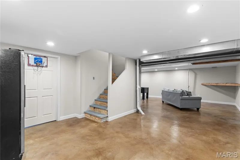 Finished interior space featuring stained concrete flooring, recessed lighting, and a built-in wall shelf — 838 Emerald Place Drive, St Charles, MO 63304