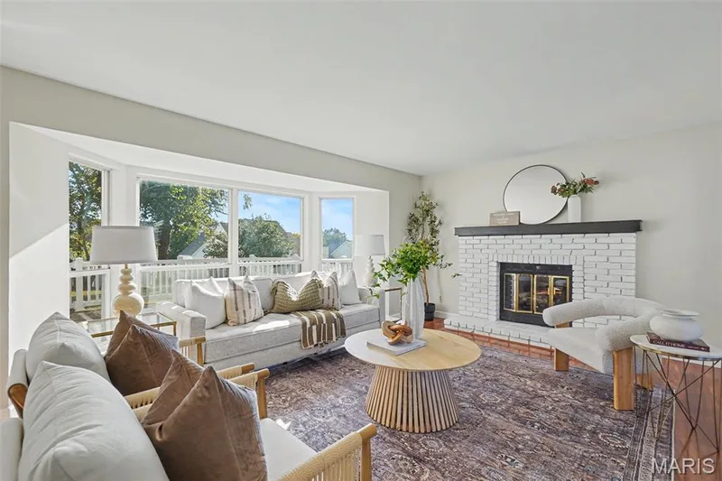 Light-filled interior featuring a bay window and gas fireplace — 11 Castlio Court, St Charles, MO 63304