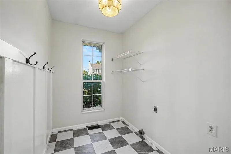 Laundry room on main level with board and batten wall — 11 Castlio Court, St Charles, MO 63304