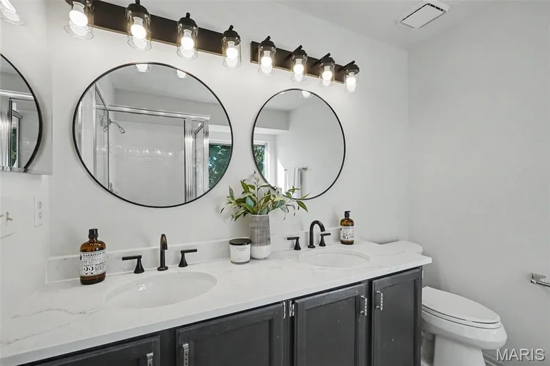 Dual-sink vanity featuring a quartz countertop — 11 Castlio Court, St Charles, MO 63304