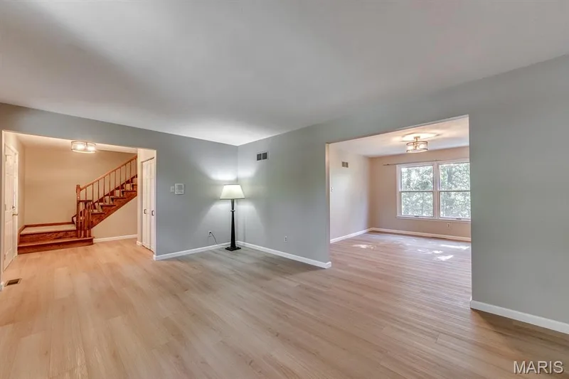 Here's a view from the living room corner into dining and foyer.  The flow in the lower level is wonderful because of the big openings. — 3030 Woodlands, Wildwood, MO 63038