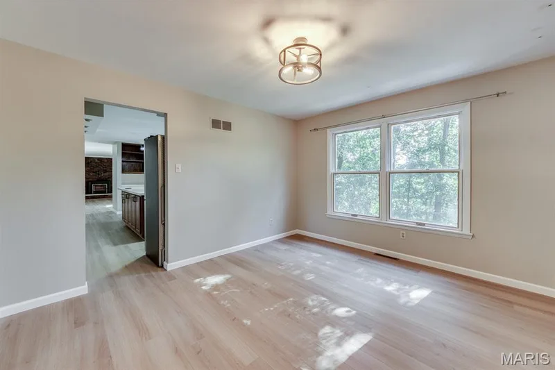 The dining room offers views of the back of the property. — 3030 Woodlands, Wildwood, MO 63038