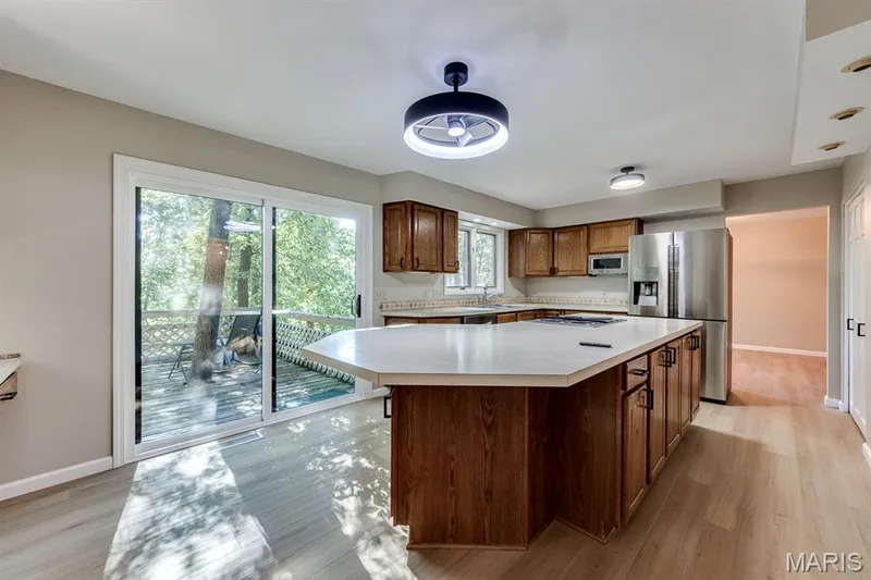This wonderful kitchen island offers seating for the family. — 3030 Woodlands, Wildwood, MO 63038