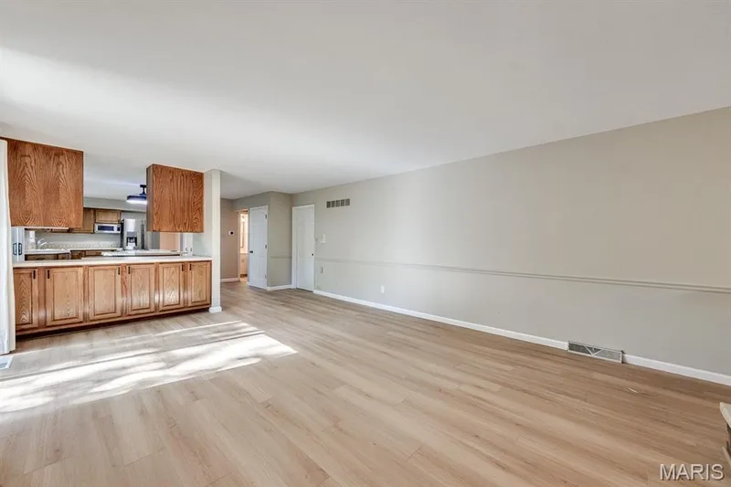 Here's the separation between the kitchen and family space. — 3030 Woodlands, Wildwood, MO 63038