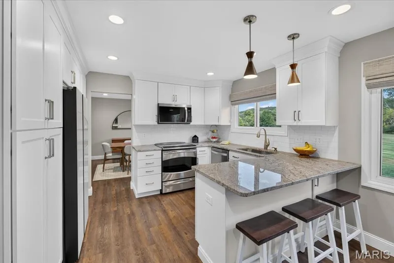 The kitchen was completely updated in 2023 and opens to breakfast area and family room. — 15056 Isleview Drive, Chesterfield, MO 63017