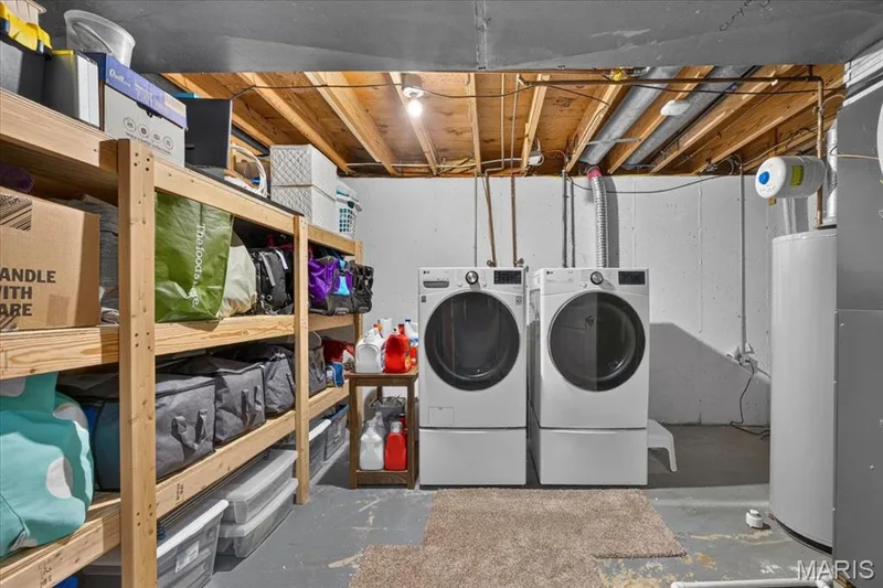 Lower level laundry room with built-in shelving. — 15056 Isleview Drive, Chesterfield, MO 63017