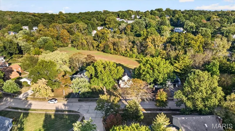 Drone view highlights the expansive common ground and wooded setting directly behind the home. — 15056 Isleview Drive, Chesterfield, MO 63017