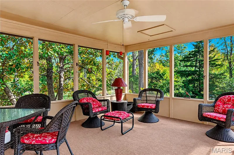 Screened-in porch featuring expansive window panels, a neutral-toned ceiling, and a central ceiling fan — 15552 Chequer Drive, Chesterfield, MO 63017