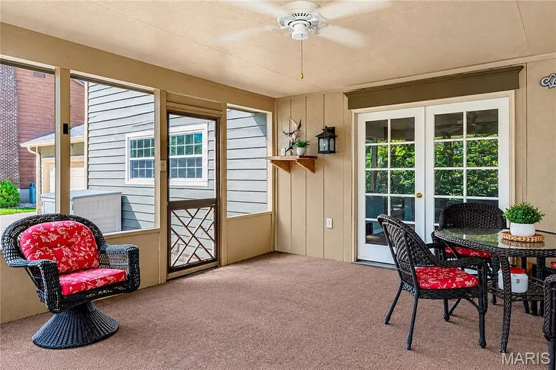 Screened-in porch featuring full-height screen walls, ceiling fan, solid-surface flooring, and glass-paneled double doors — 15552 Chequer Drive, Chesterfield, MO 63017
