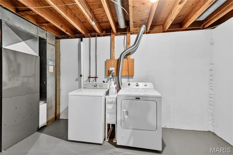 Utility area featuring poured concrete foundation walls, exposed joist ceiling, and painted concrete flooring — 15552 Chequer Drive, Chesterfield, MO 63017