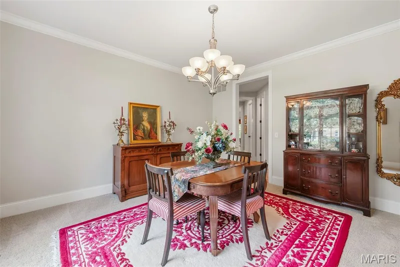 Dining room featuring neutral wall color, crown molding, and a multi-arm metallic chandelier — 112 Castlewood Estates Drive, O'Fallon, MO 63368