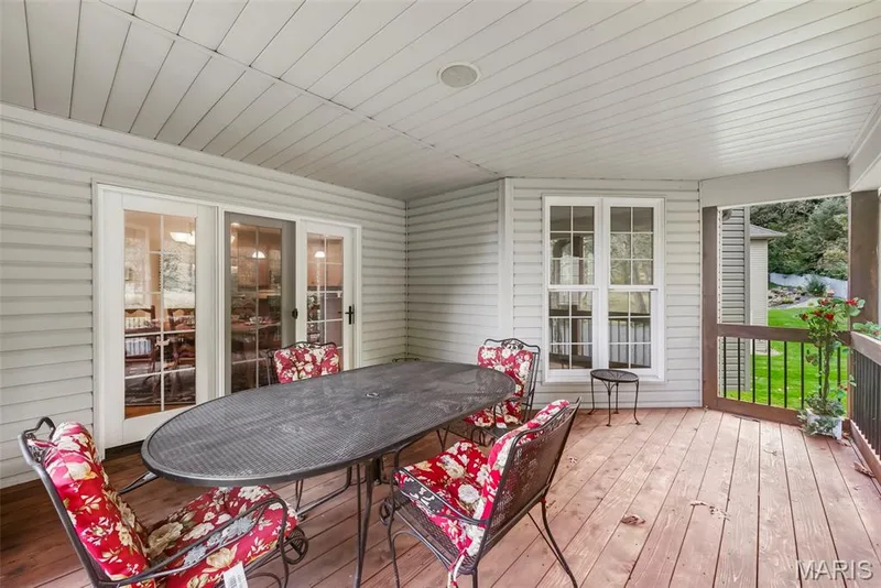 Covered Deck featuring wood-finish decking, light-toned horizontal siding, and integrated recessed lighting — 112 Castlewood Estates Drive, O'Fallon, MO 63368