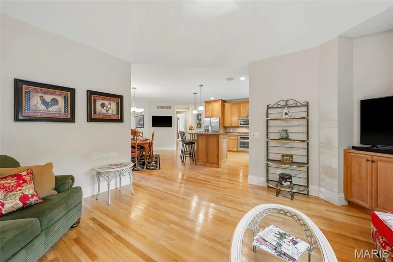 Hearth Room featuring wood-finish flooring — 112 Castlewood Estates Drive, O'Fallon, MO 63368