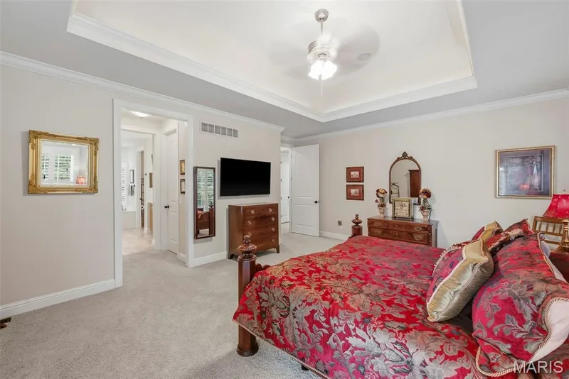 Primary Bedroom with Tray ceiling and Dual Walk-In Closets — 112 Castlewood Estates Drive, O'Fallon, MO 63368