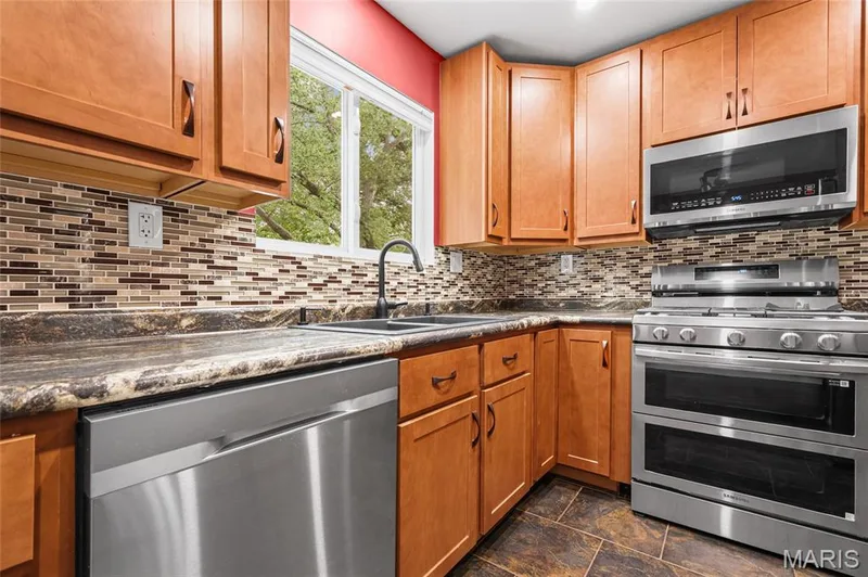 Newer stainless appliances: gas range with double oven, over-range microwave and dishwasher. — 510 Keeney Drive, St Charles, MO 63304