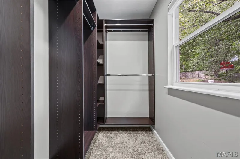 Primary walk-in closet with built-in closet system and window. — 510 Keeney Drive, St Charles, MO 63304