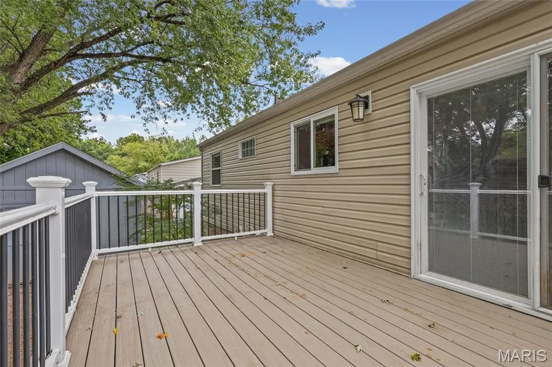 Composite deck off the dining slider with white rail and black balusters. — 510 Keeney Drive, St Charles, MO 63304