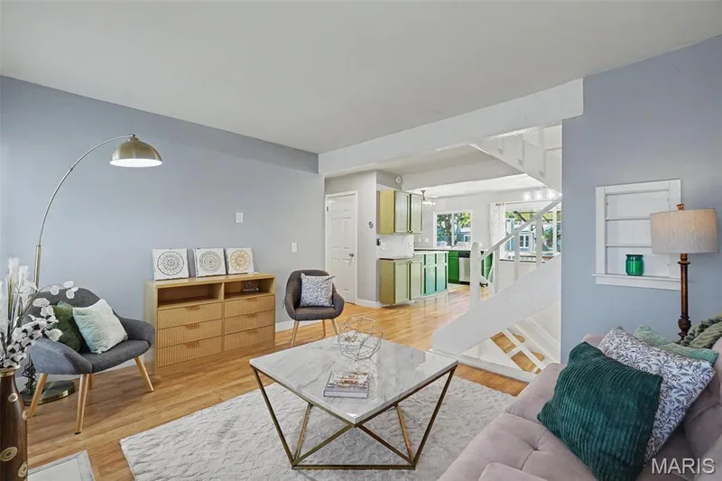 Hardwood flooring, painted interior walls, white staircase, and built-in wall niche — 81 Schooner Lane #1, Lake St. Louis, MO 63367