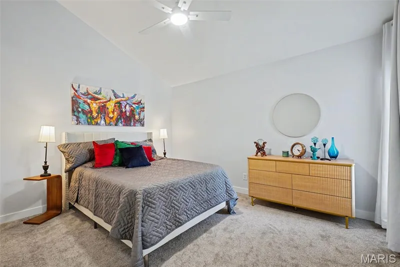 Vaulted ceiling with a ceiling fan, light gray carpet, and white walls — 81 Schooner Lane #1, Lake St. Louis, MO 63367