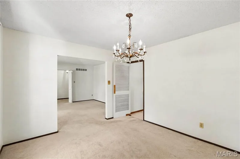 Elegant dining room flows naturally between the living room and kitchen. — 2311 Blue Hill Road, Chesterfield, MO 63017