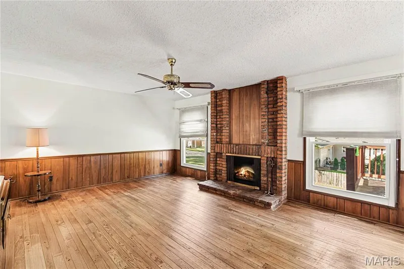 Windows flanking the fireplace allow for plenty of natural light and plenty of space for relaxing. — 2311 Blue Hill Road, Chesterfield, MO 63017