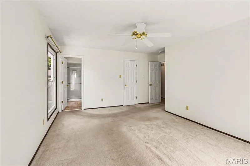Primary bedroom features a walk-in closet and attached bath with shower. — 2311 Blue Hill Road, Chesterfield, MO 63017