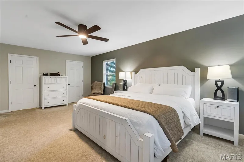 Neutral wall tones, accent wall, multi-panel doors, carpeting, and ceiling fan with integrated lighting — 1444 Eagle Ridge Road, Wildwood, MO 63038