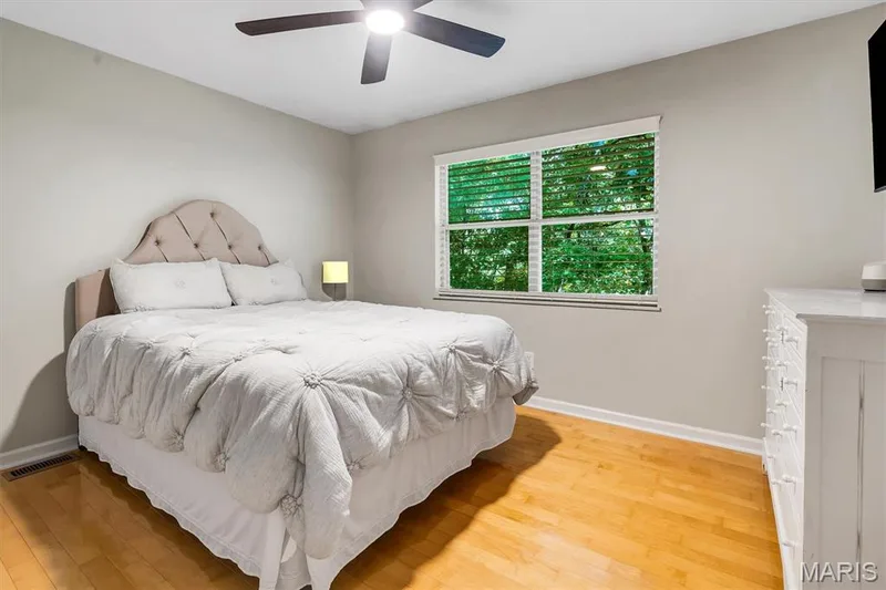 Neutral interior wall color, wood-finish flooring, multi-pane window, and ceiling-mounted fan — 1444 Eagle Ridge Road, Wildwood, MO 63038
