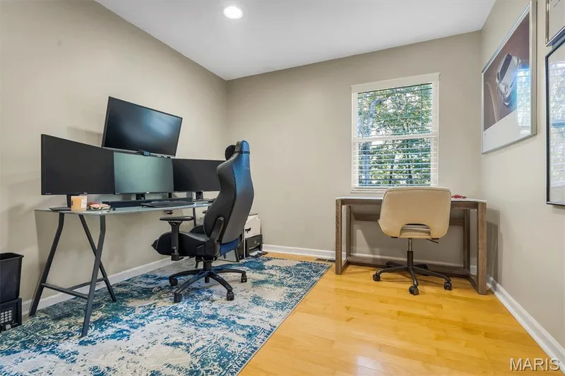 Neutral-toned room featuring hardwood flooring, recessed lighting, and a window with horizontal blinds — 1444 Eagle Ridge Road, Wildwood, MO 63038