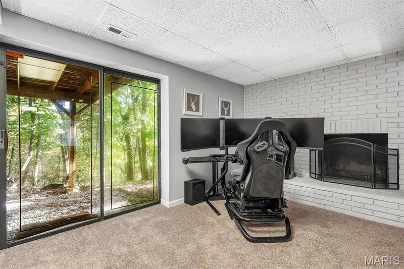 Painted brick fireplace, glass sliding door, and neutral carpeting — 1444 Eagle Ridge Road, Wildwood, MO 63038