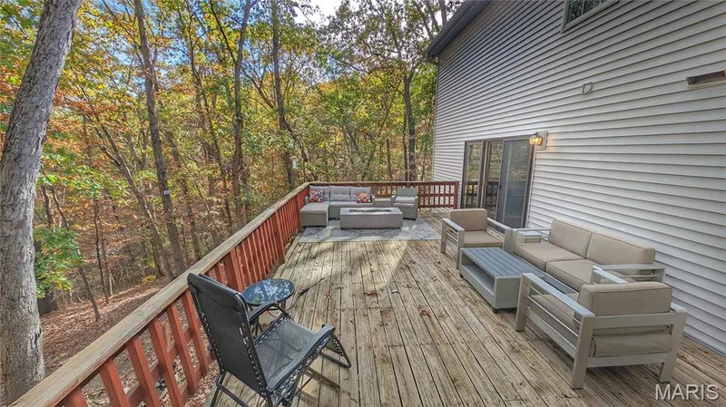 Raised wooden deck featuring a horizontal-rail balustrade and sliding glass door access to the exterior — 1444 Eagle Ridge Road, Wildwood, MO 63038