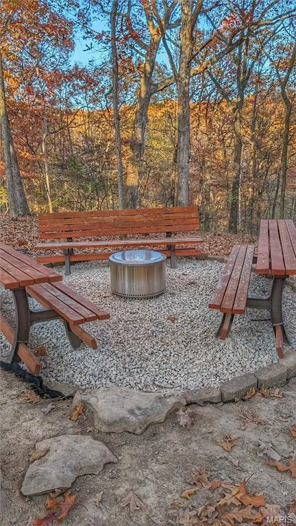 Gravel-surfaced fire pit area with stone edging and metal fire feature — 1444 Eagle Ridge Road, Wildwood, MO 63038