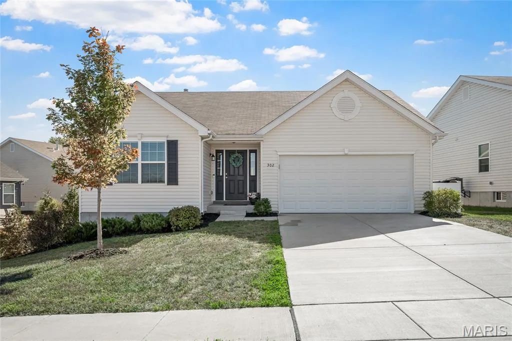 Siding exterior, attached garage, concrete driveway, and front landscaping — 302 Creek Sound Court, Wentzville, MO 63385