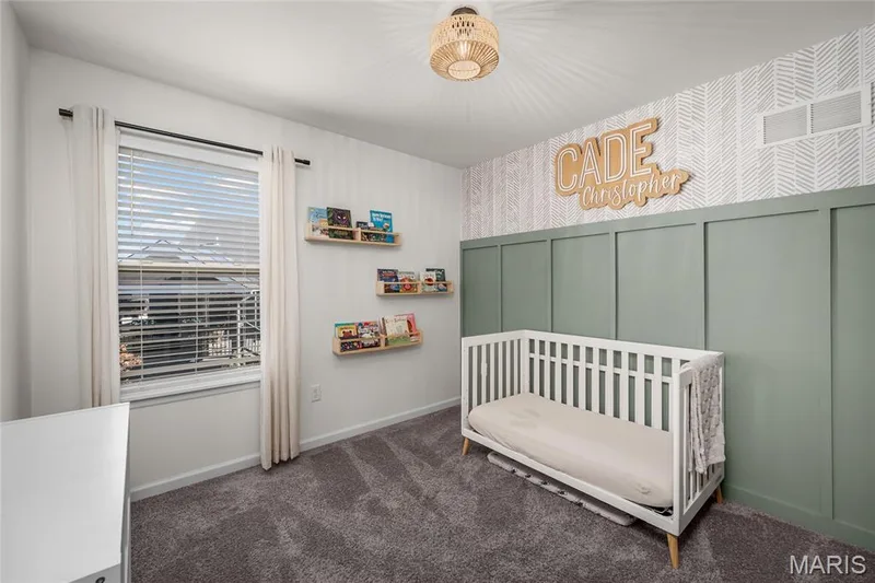 Ceiling-mounted light fixture with a woven shade, accent wall featuring board and batten paneling, patterned wallpaper, recessed window, and gray carpeting — 302 Creek Sound Court, Wentzville, MO 63385