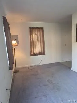 Living Room is carpeted, and a nice double hung window... — 304 W Pitman Street, O'Fallon, MO 63366