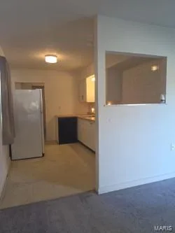 Kitchenette with white cabinetry, portable dishwasher, and pass-through window — 304 W Pitman Street, O'Fallon, MO 63366