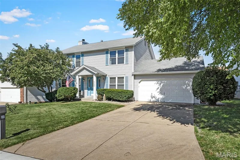 Two-story residence featuring light-colored siding and a covered entry — 445 Lantana Lane, St Peters, MO 63376