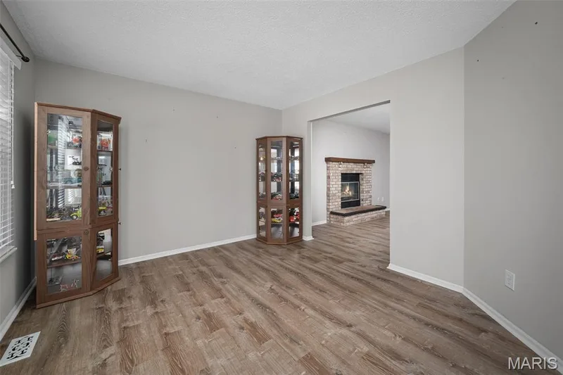 Neutral paint palette, and a doorway leading to a brick fireplace — 445 Lantana Lane, St Peters, MO 63376
