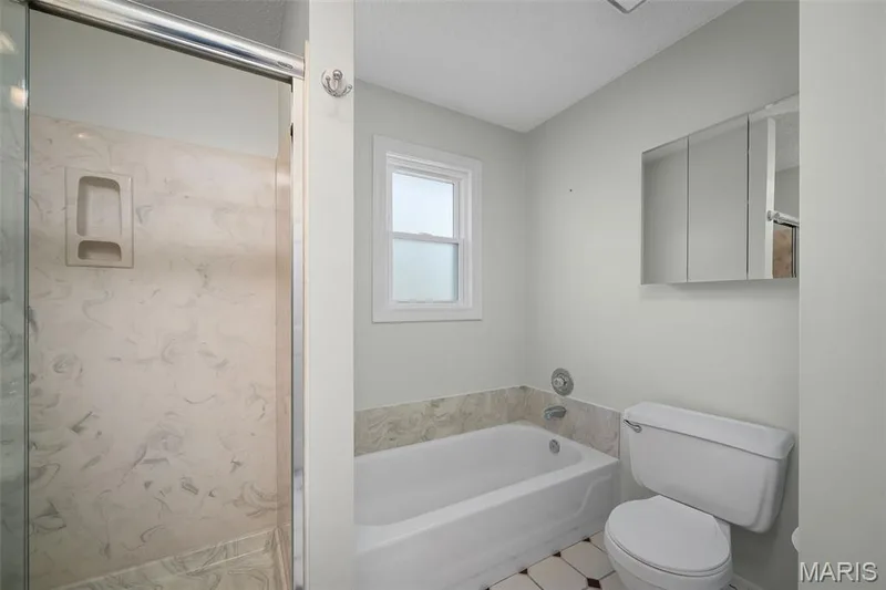 Shower with glass enclosure, built-in shelf, and cultured marble surround — 445 Lantana Lane, St Peters, MO 63376