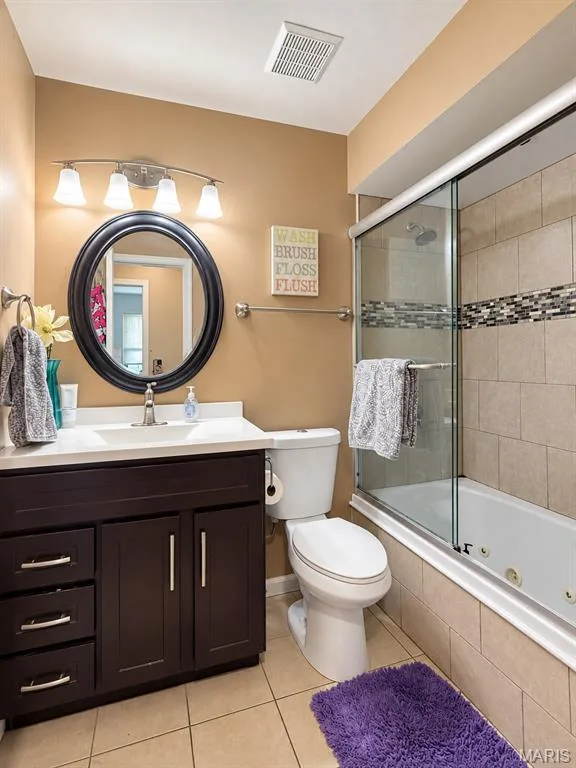 Main guest bathroom w/ glass shower door, jacuzzi tub shower combo and ceramic tile flooring — 111 Valvero Drive, St Charles, MO 63304