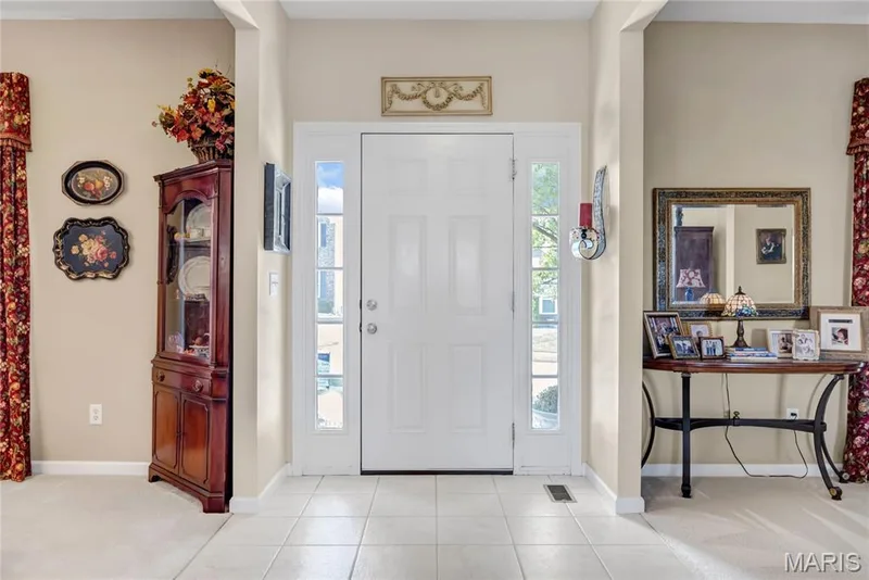 Entryway featuring a white paneled front door, full-length sidelight windows, and neutral tile flooring — 2061 Avalon Mist Circle, Dardenne Prairie, MO 63368