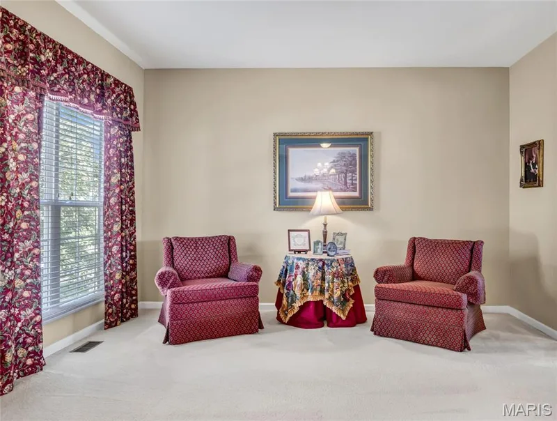 Neutral-toned interior space featuring light-colored wall-to-wall carpeting and a single window with horizontal blinds — 2061 Avalon Mist Circle, Dardenne Prairie, MO 63368