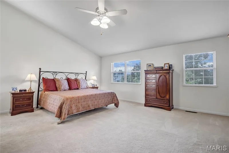 Spacious room featuring a vaulted ceiling, wall-to-wall carpeting, and a central ceiling fan with integrated lighting — 2061 Avalon Mist Circle, Dardenne Prairie, MO 63368